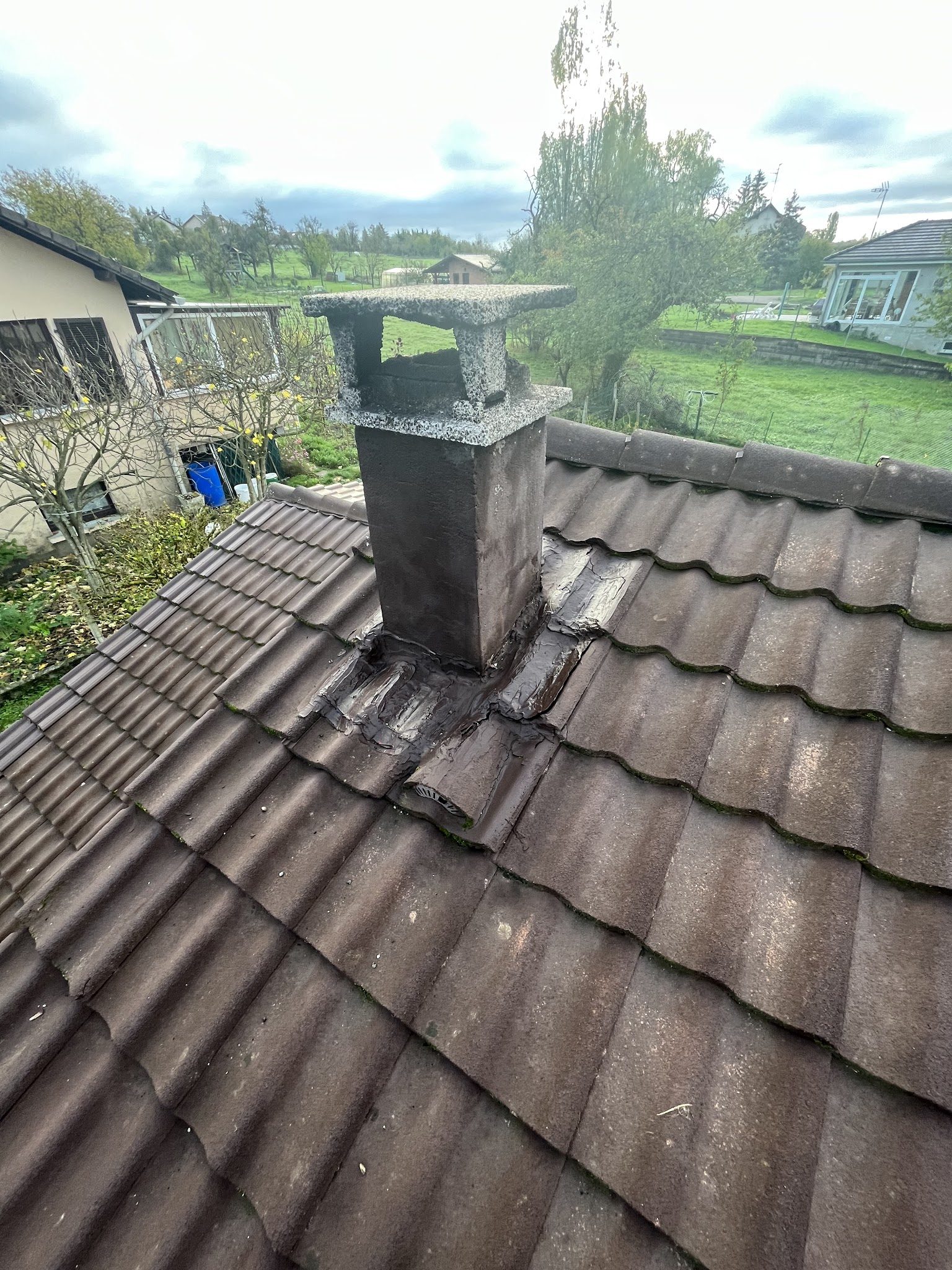 Souche de cheminée et ses raccords sur un toit de tuiles